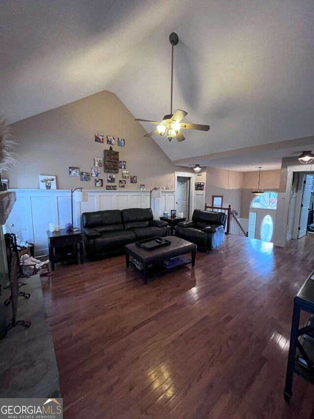 living room with wood-type flooring, ceiling fan, and vaulted ceiling