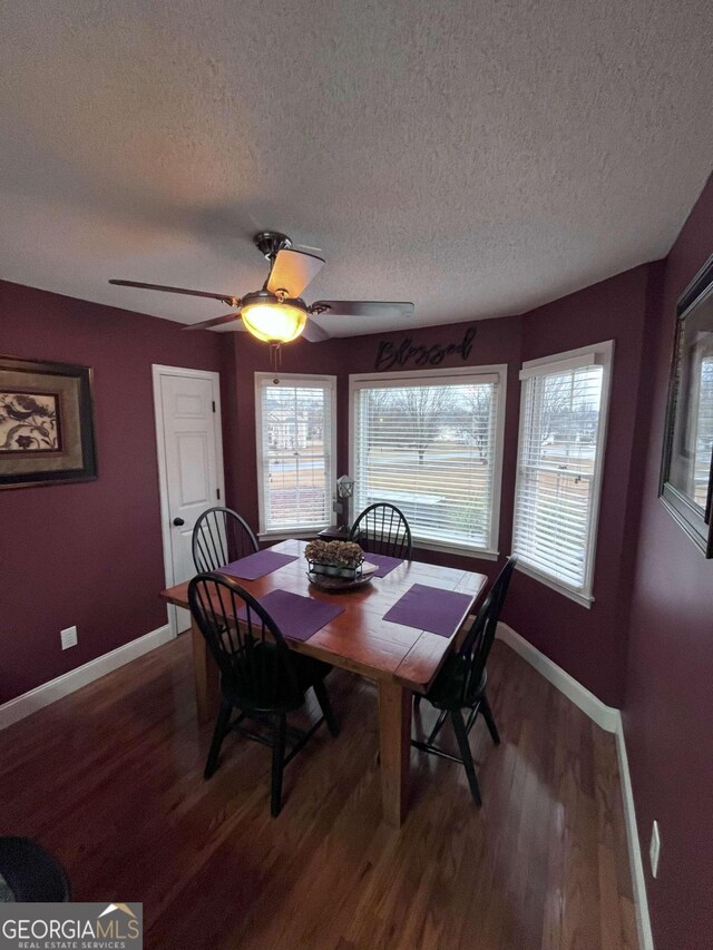 dining space with a textured ceiling, ceiling fan, and hardwood / wood-style floors