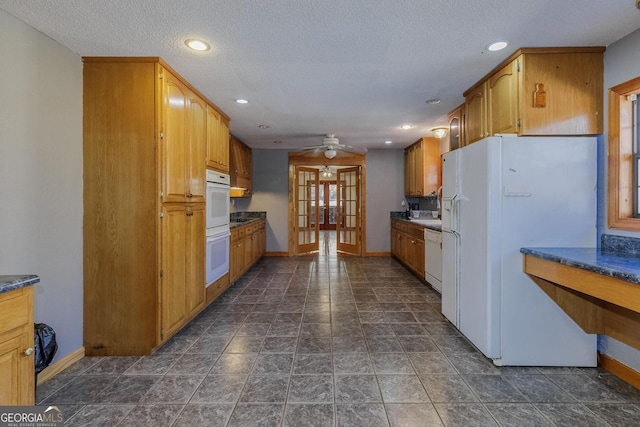 kitchen with french doors, a textured ceiling, white appliances, and ceiling fan