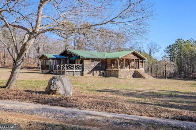 view of front facade featuring a front yard and a sunroom