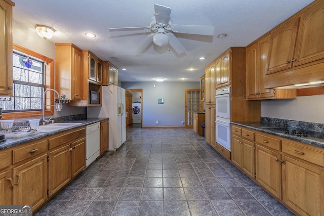 kitchen with ceiling fan, sink, washer / clothes dryer, a textured ceiling, and white appliances