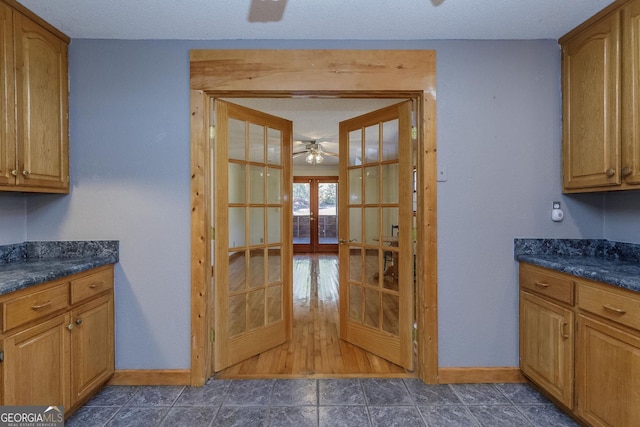 kitchen with ceiling fan, a textured ceiling, and french doors