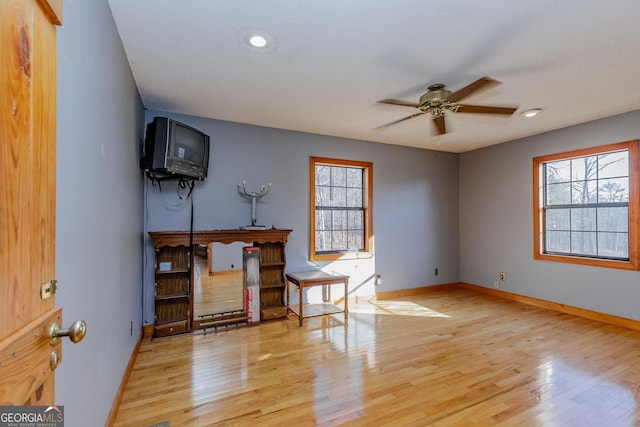 interior space with ceiling fan and light hardwood / wood-style floors