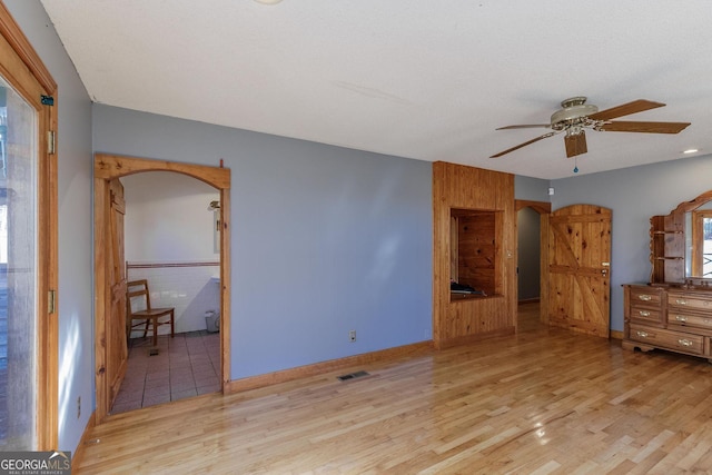 unfurnished bedroom featuring ceiling fan and light hardwood / wood-style flooring