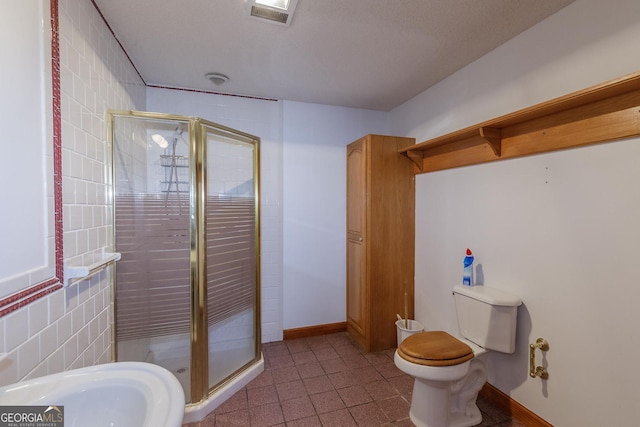 bathroom with an enclosed shower and toilet