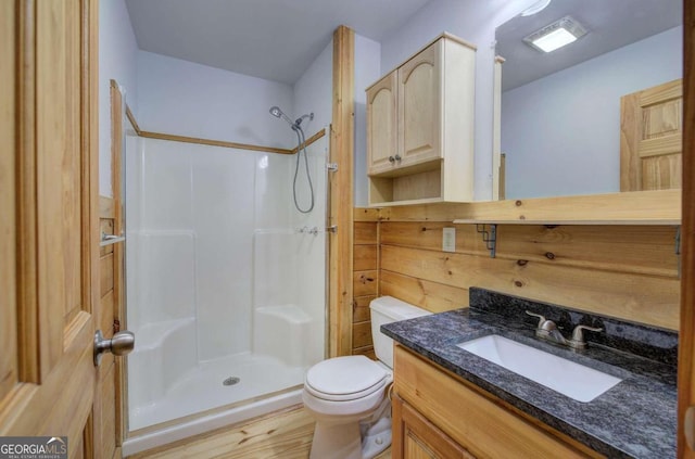 bathroom featuring toilet, a shower, vanity, and wood-type flooring