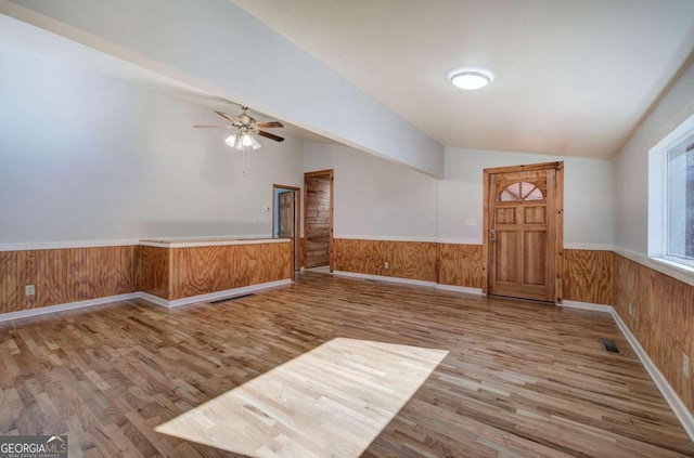 unfurnished room with ceiling fan, light hardwood / wood-style flooring, and lofted ceiling