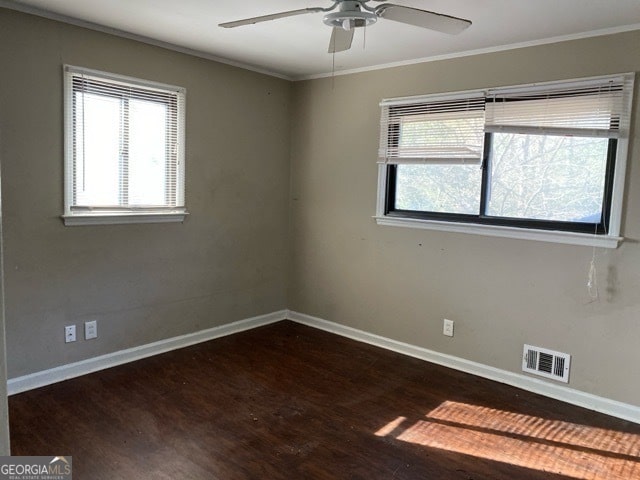 spare room featuring ornamental molding, ceiling fan, and dark hardwood / wood-style floors