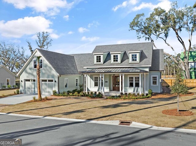 cape cod house with a porch and a garage