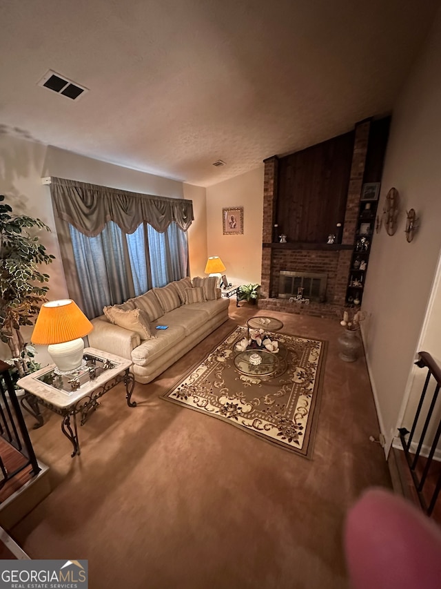 living room with brick wall and a fireplace