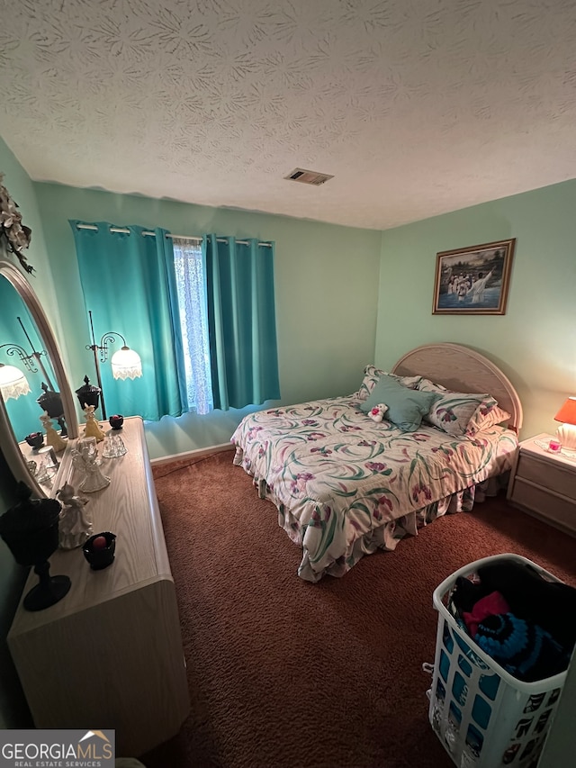 carpeted bedroom featuring a textured ceiling