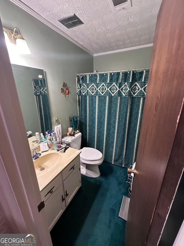 bathroom featuring toilet, a textured ceiling, vanity, and crown molding