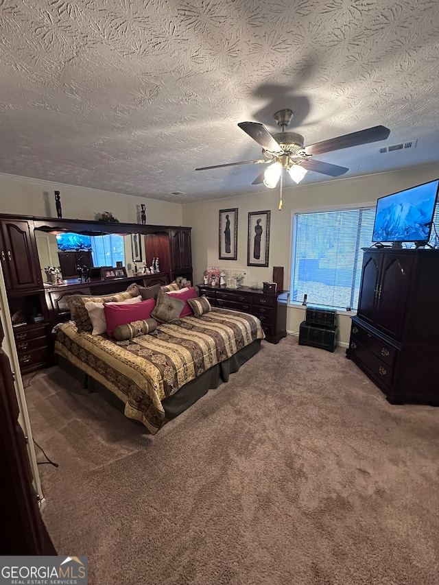 carpeted bedroom featuring ceiling fan and a textured ceiling