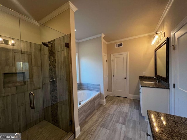 bathroom featuring vanity, shower with separate bathtub, and crown molding