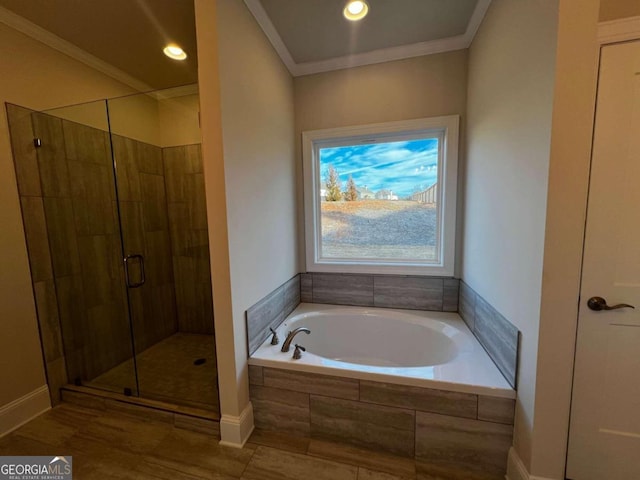 bathroom featuring independent shower and bath and ornamental molding