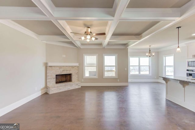 unfurnished living room featuring dark hardwood / wood-style floors, coffered ceiling, and a wealth of natural light