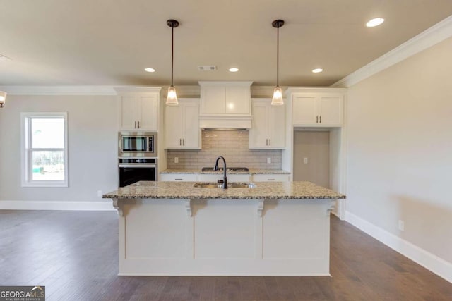 kitchen featuring dark hardwood / wood-style floors, a kitchen island with sink, light stone counters, custom range hood, and stainless steel appliances