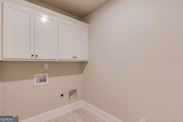 laundry room with washer hookup, electric dryer hookup, and cabinets