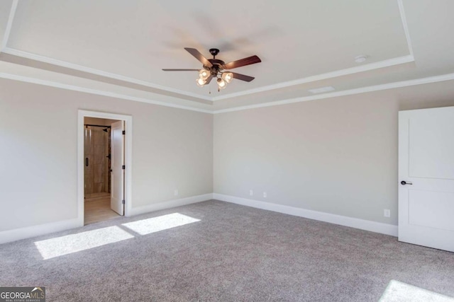 carpeted empty room featuring ceiling fan and a tray ceiling