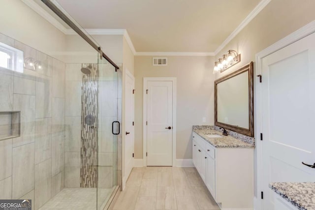 bathroom featuring vanity, tile flooring, a shower with door, and ornamental molding