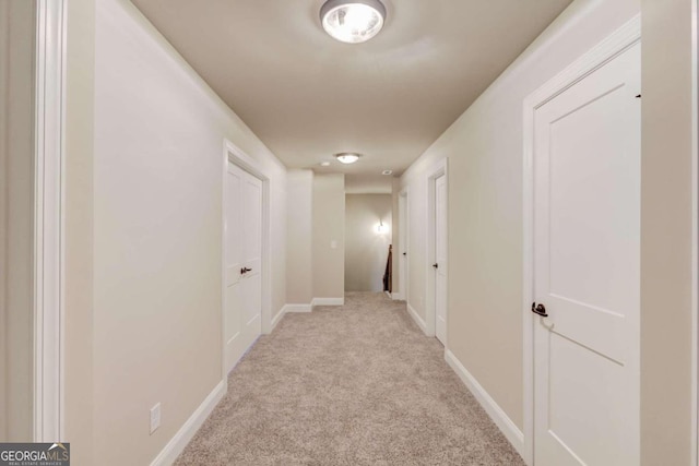 hallway featuring light carpet