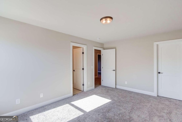 unfurnished bedroom featuring light colored carpet