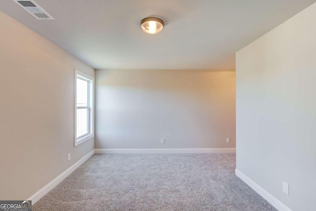 unfurnished room with light colored carpet