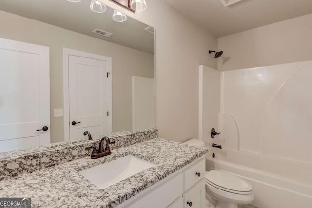 full bathroom with toilet, vanity with extensive cabinet space, and tub / shower combination