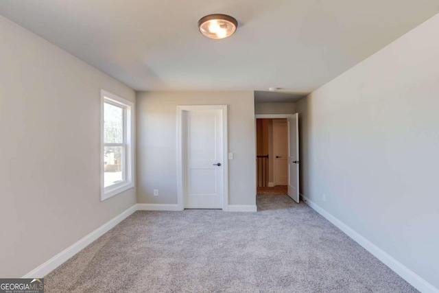 unfurnished bedroom with light colored carpet