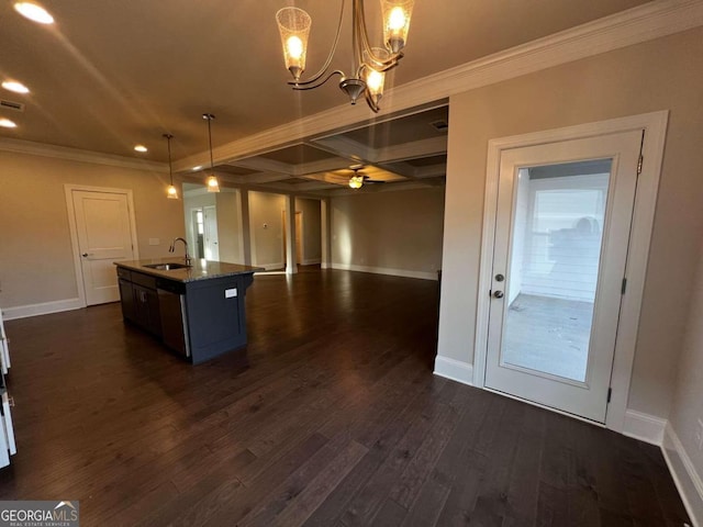 kitchen with decorative light fixtures, dark hardwood / wood-style flooring, crown molding, an island with sink, and sink