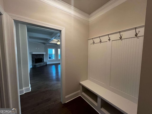 mudroom with coffered ceiling, dark wood-type flooring, ceiling fan, a fireplace, and ornamental molding