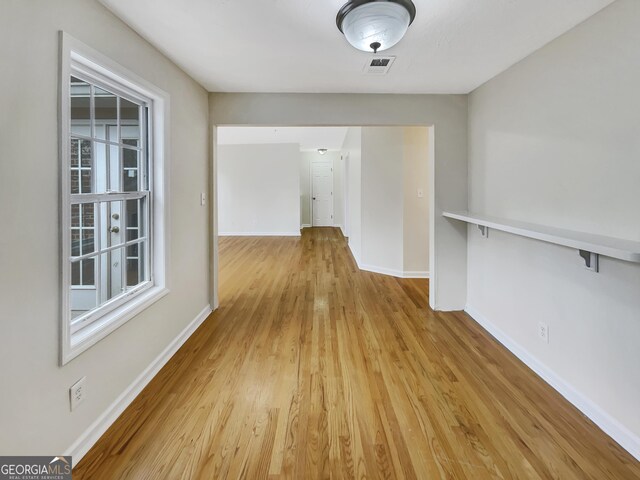 corridor featuring light hardwood / wood-style floors and a wealth of natural light