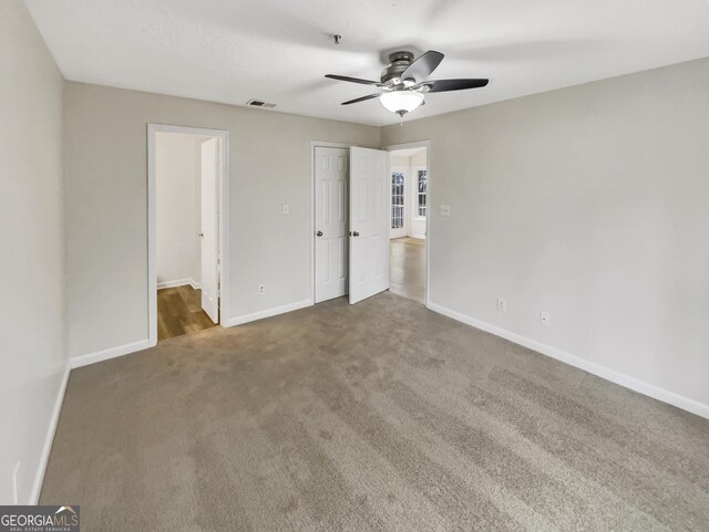 unfurnished bedroom featuring carpet and ceiling fan