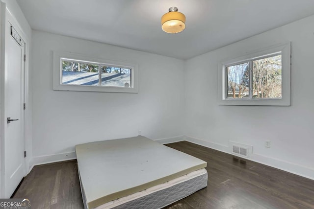 bedroom with dark wood-type flooring