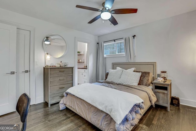 bedroom with ensuite bathroom, ceiling fan, and dark wood-type flooring