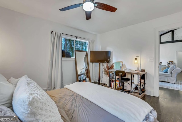 bedroom with ceiling fan and dark hardwood / wood-style floors