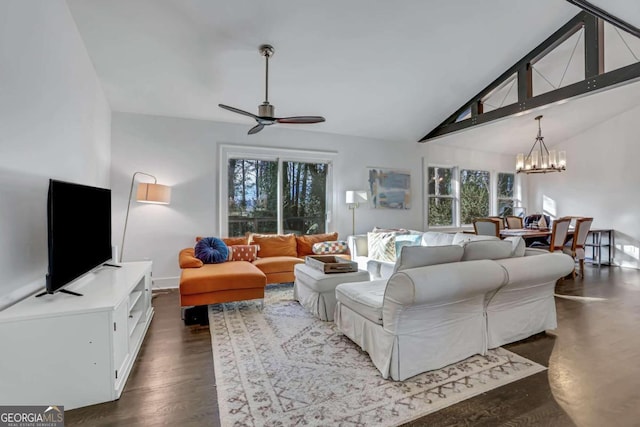 living room featuring plenty of natural light, dark hardwood / wood-style flooring, ceiling fan with notable chandelier, and beamed ceiling