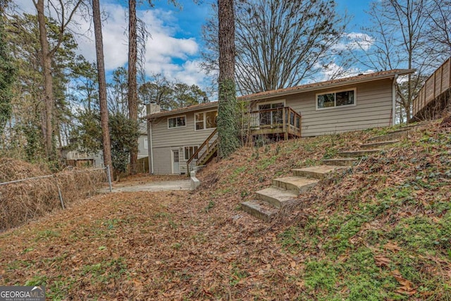 back of house featuring a wooden deck