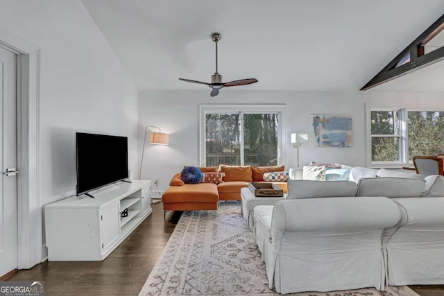 living room featuring dark hardwood / wood-style flooring, ceiling fan, lofted ceiling, and plenty of natural light