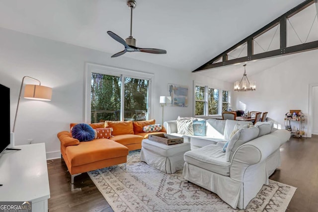 living room with ceiling fan with notable chandelier, vaulted ceiling with beams, and dark wood-type flooring