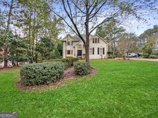 rear view of house with ceiling fan and a patio area