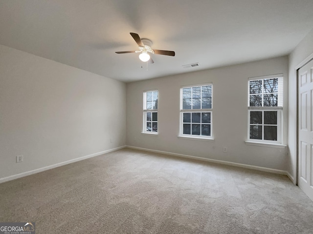 carpeted empty room featuring ceiling fan