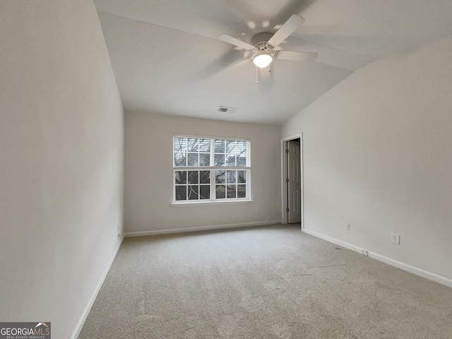 carpeted empty room featuring ceiling fan and vaulted ceiling