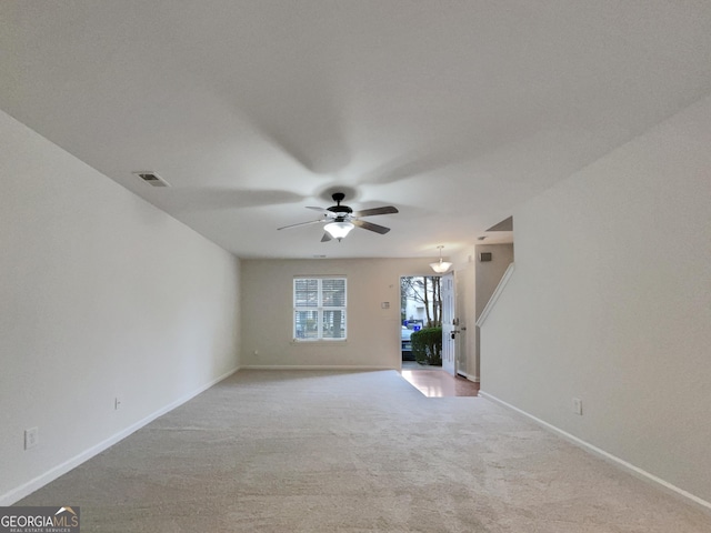 spare room with light colored carpet and ceiling fan