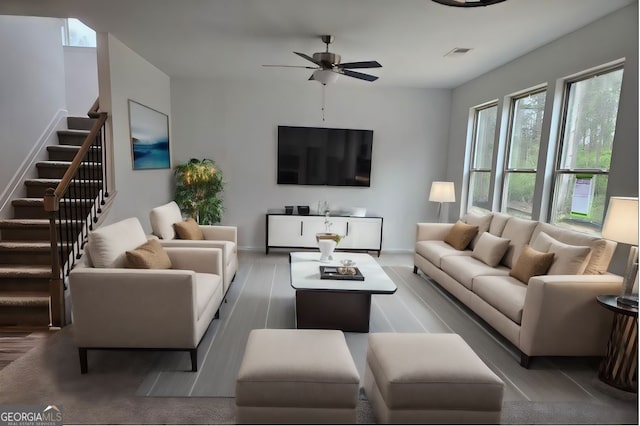 living room featuring ceiling fan and hardwood / wood-style floors