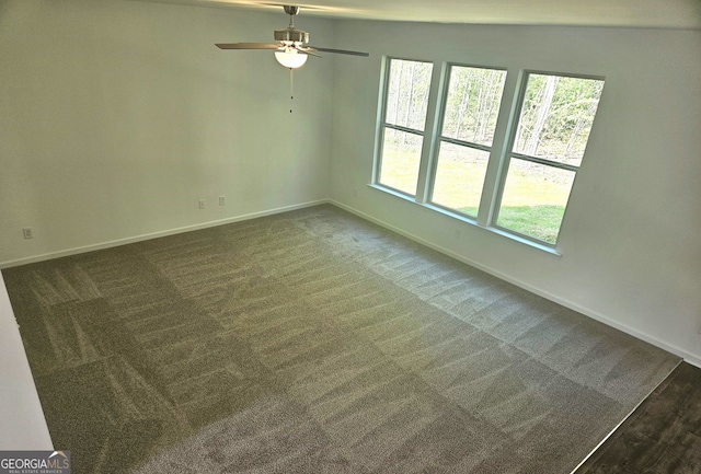 carpeted empty room featuring ceiling fan and vaulted ceiling