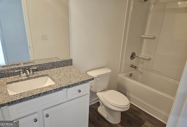 full bathroom with vanity with extensive cabinet space, hardwood / wood-style floors, toilet, and tub / shower combination