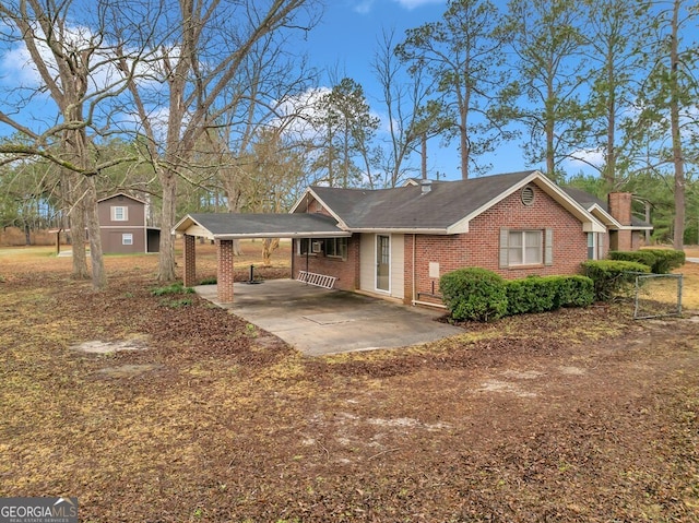 single story home featuring a carport