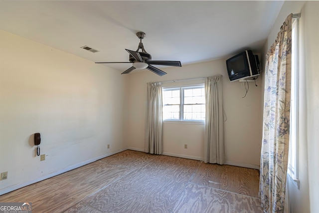 empty room with ceiling fan and light wood-type flooring