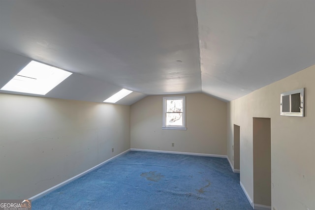 additional living space with lofted ceiling with skylight and light carpet